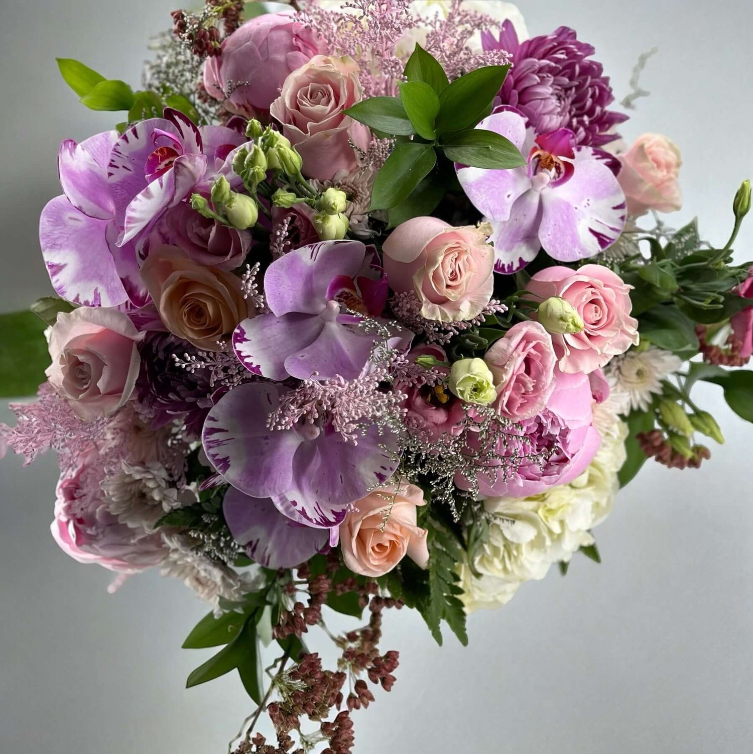 Elegant Bouquets featuring pink roses and orchids, showcasing a timeless expression of beauty and grace.