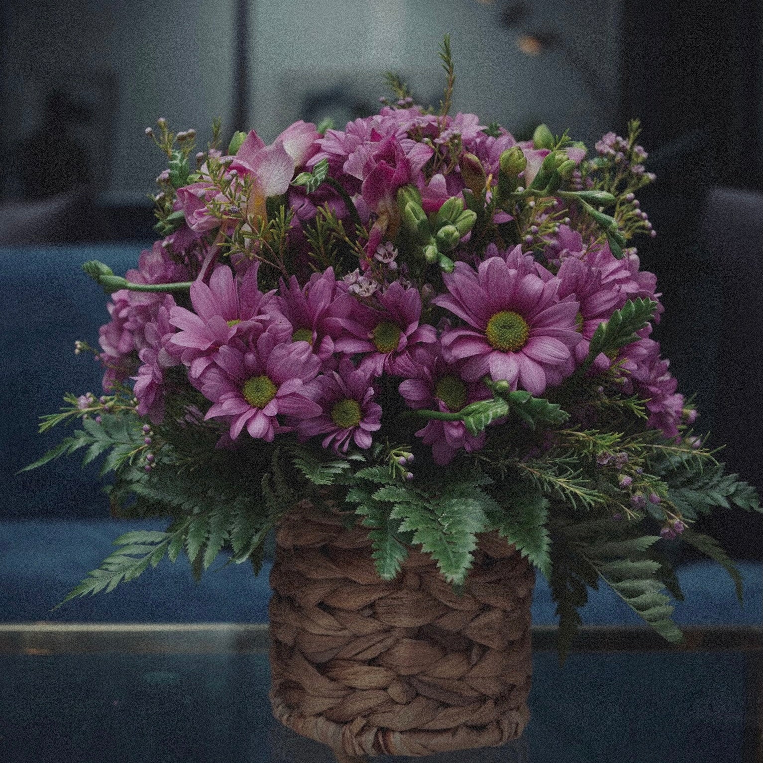 Bright and cheerful spring flower bouquet with colorful tulips, daisies, and fresh greenery.