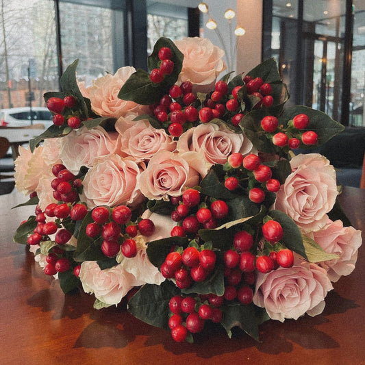 Love-inspired flower arrangement with pink roses, and heart-shaped accents, the ultimate gift for anniversaries