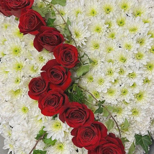 Heart-shaped floral sympathy arrangement with white chrysanthemums and cascading red roses, luxury funeral tribute in Toronto, same-day delivery.