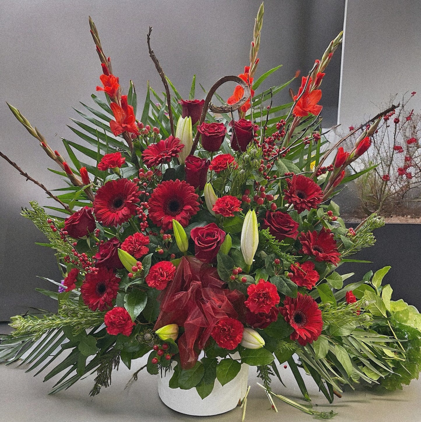 Luxury Radiant Red Splendor floral arrangement with roses, gerberas, carnations, perfect for sympathy or funeral in Toronto, same-day delivery.