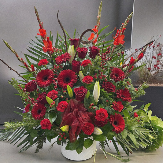 Luxury Radiant Red Splendor floral arrangement with roses, gerberas, carnations, perfect for sympathy or funeral in Toronto, same-day delivery.