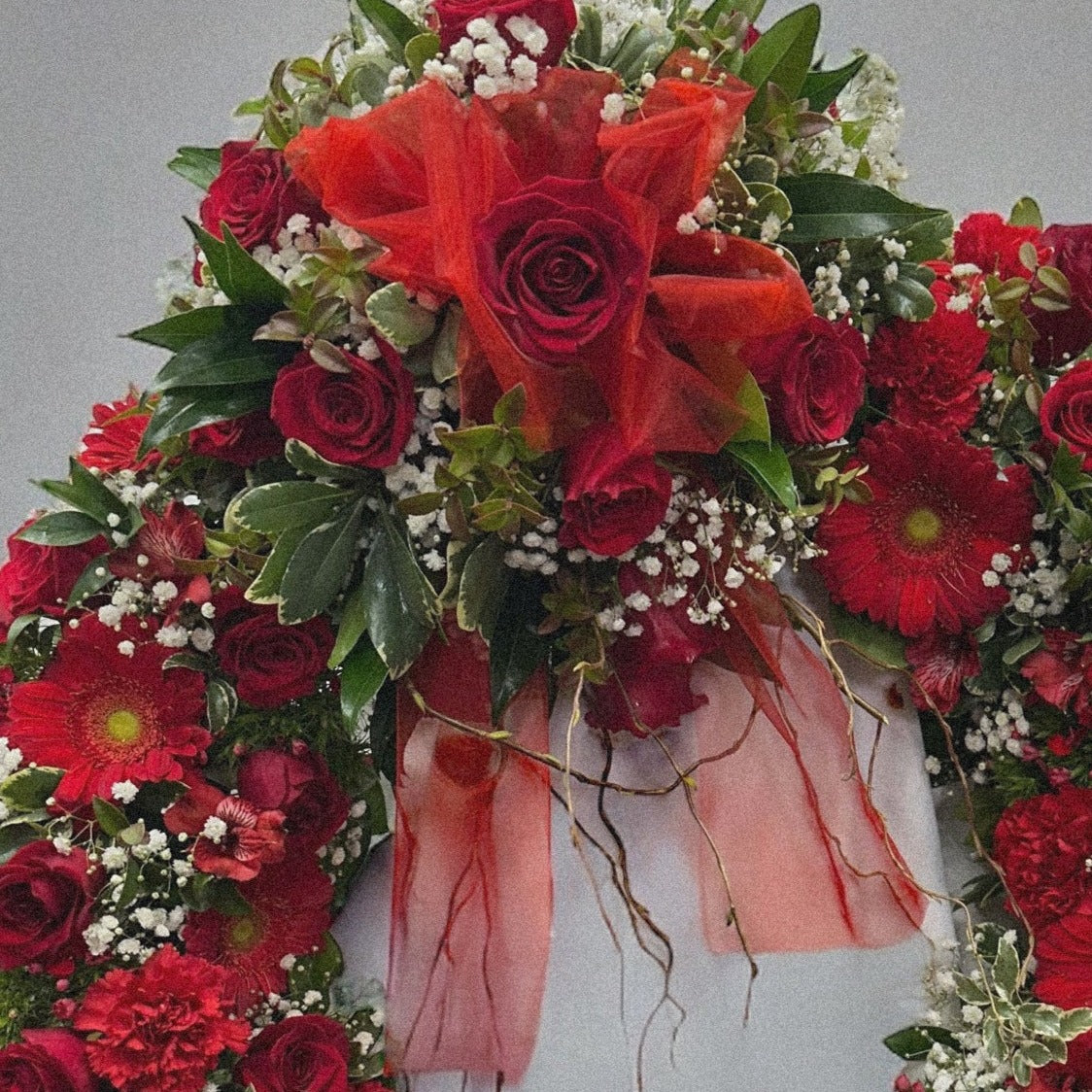 Luxury Crimson Tribute sympathy wreath with red roses for funeral arrangements. Best quality, same-day delivery in Toronto & GTA.
