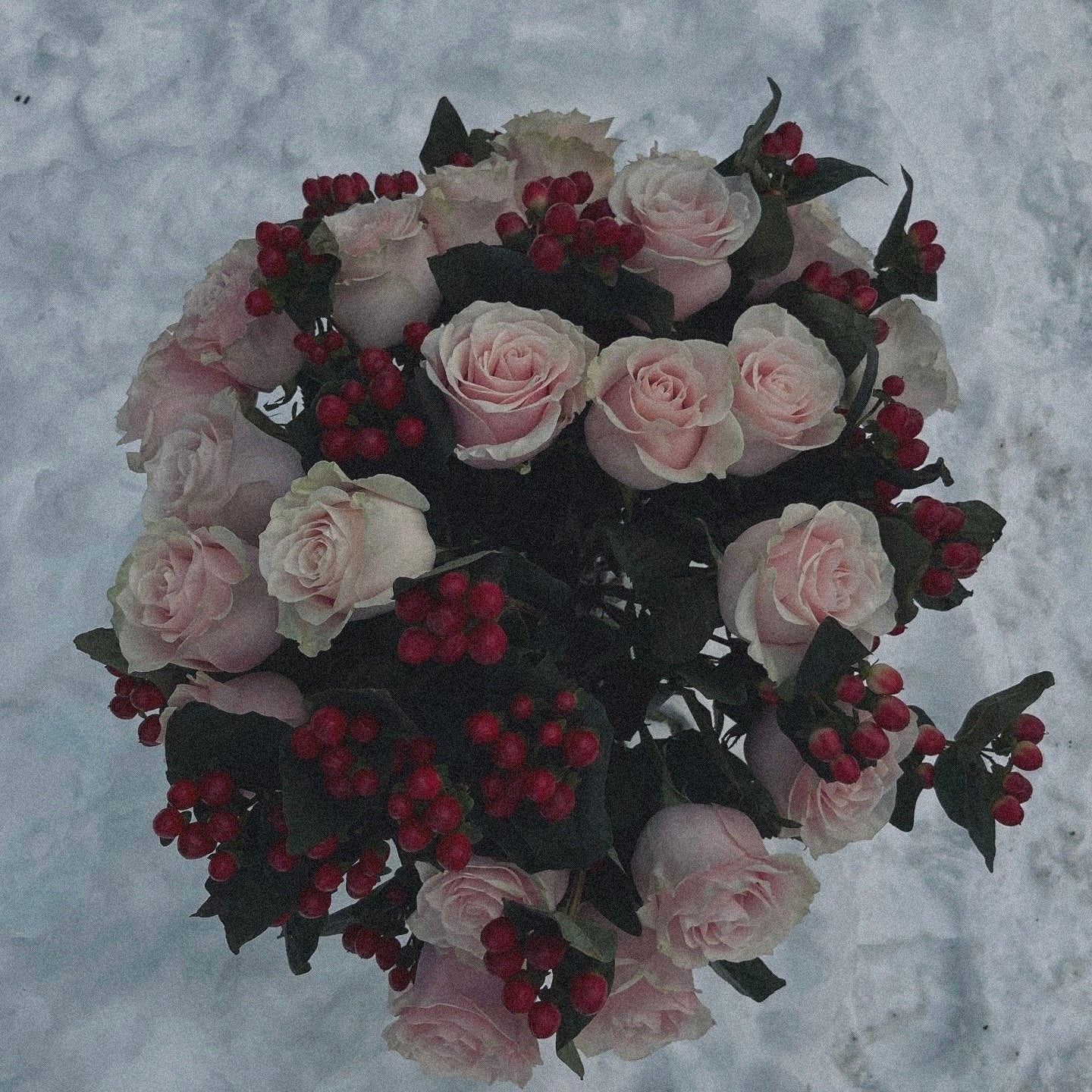 Love-inspired flower arrangement with red tulips, roses, and heart-shaped accents, the ultimate gift for anniversaries