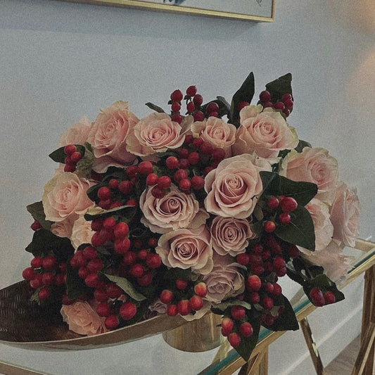 Love-inspired flower arrangement with red tulips, roses, and heart-shaped accents, the ultimate gift for anniversaries
