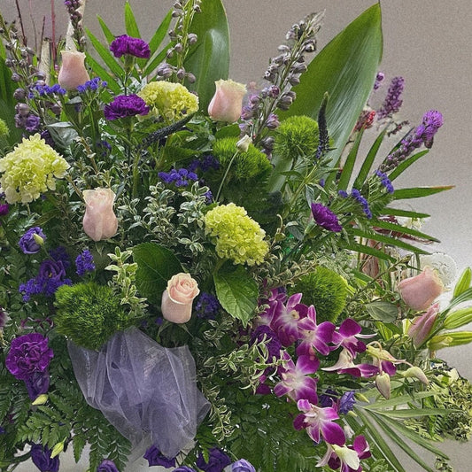 Lavender Garden Arrangement with pink roses, purple blooms, lush greenery; a serene funeral tribute for sympathy and remembrance, Toronto.