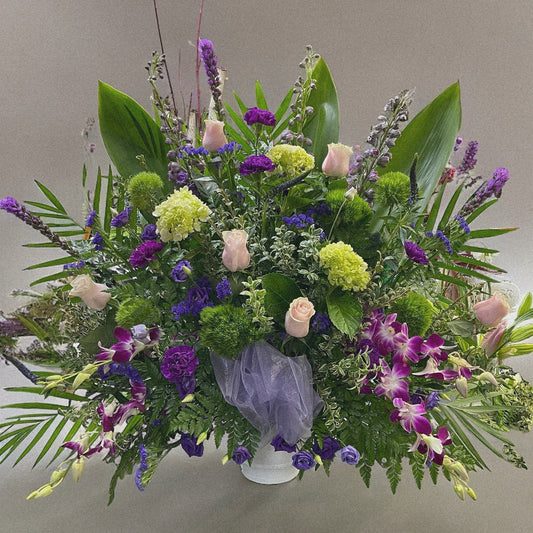 Lavender Garden Arrangement - A serene funeral tribute with soft pink roses and rich purples. Best sympathy wreaths in Toronto, same-day delivery.