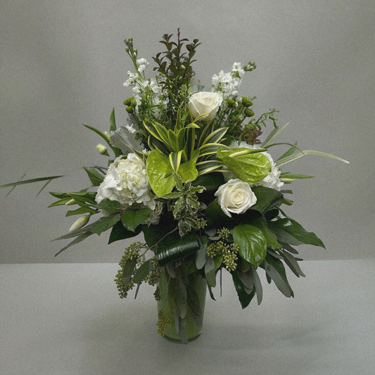 Elegant Serene Grace floral arrangement with white roses, hydrangeas, and anthuriums in a glass vase, perfect for all occasions. Best florist in Toronto, GTA.