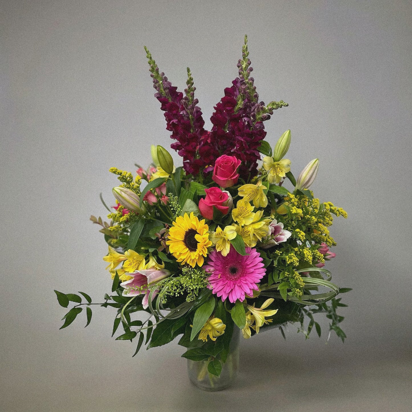 Luxury floral bouquet with handpicked roses, hydrangeas, and greenery in a glass vase, ideal for weddings, anniversaries, and celebrations.