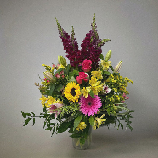 Luxury floral bouquet with handpicked roses, hydrangeas, and greenery in a glass vase, ideal for weddings, anniversaries, and celebrations.