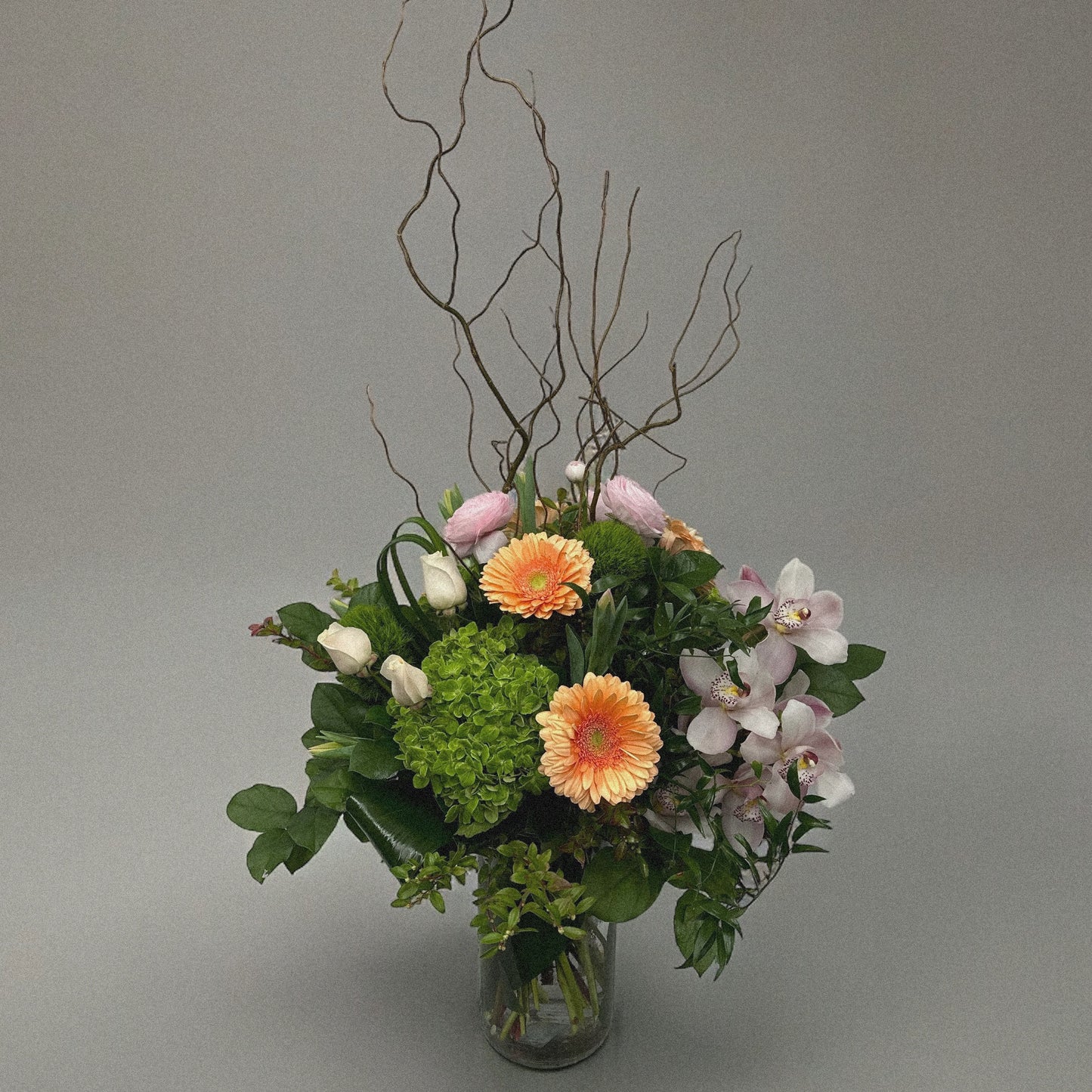 Pastel-colored spring bouquet featuring soft pink peonies, roses, and delicate filler flowers.