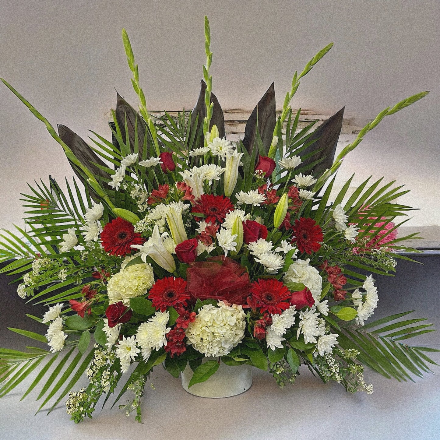 "Majestic Harmony" luxury floral funeral arrangement with red, white flowers & lush greens; best sympathy bouquet in Toronto, GTA.