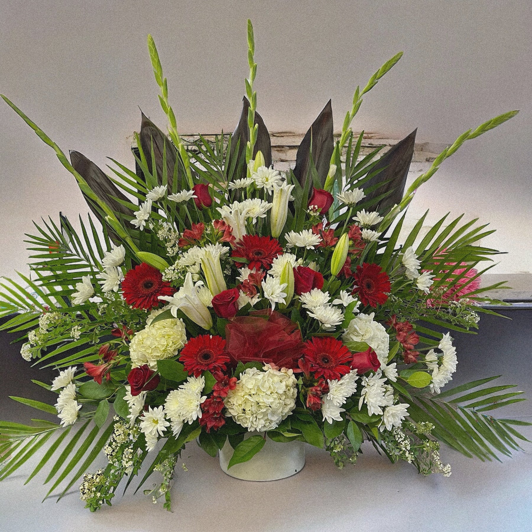 "Majestic Harmony" luxury floral funeral arrangement with red, white flowers & lush greens; best sympathy bouquet in Toronto, GTA.