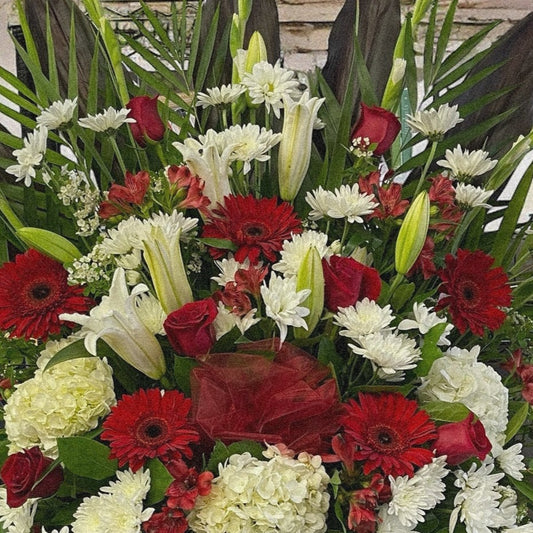 Majestic Harmony funeral arrangement with red, white, green blooms; luxury sympathy flowers, best in Toronto & GTA, same day delivery.