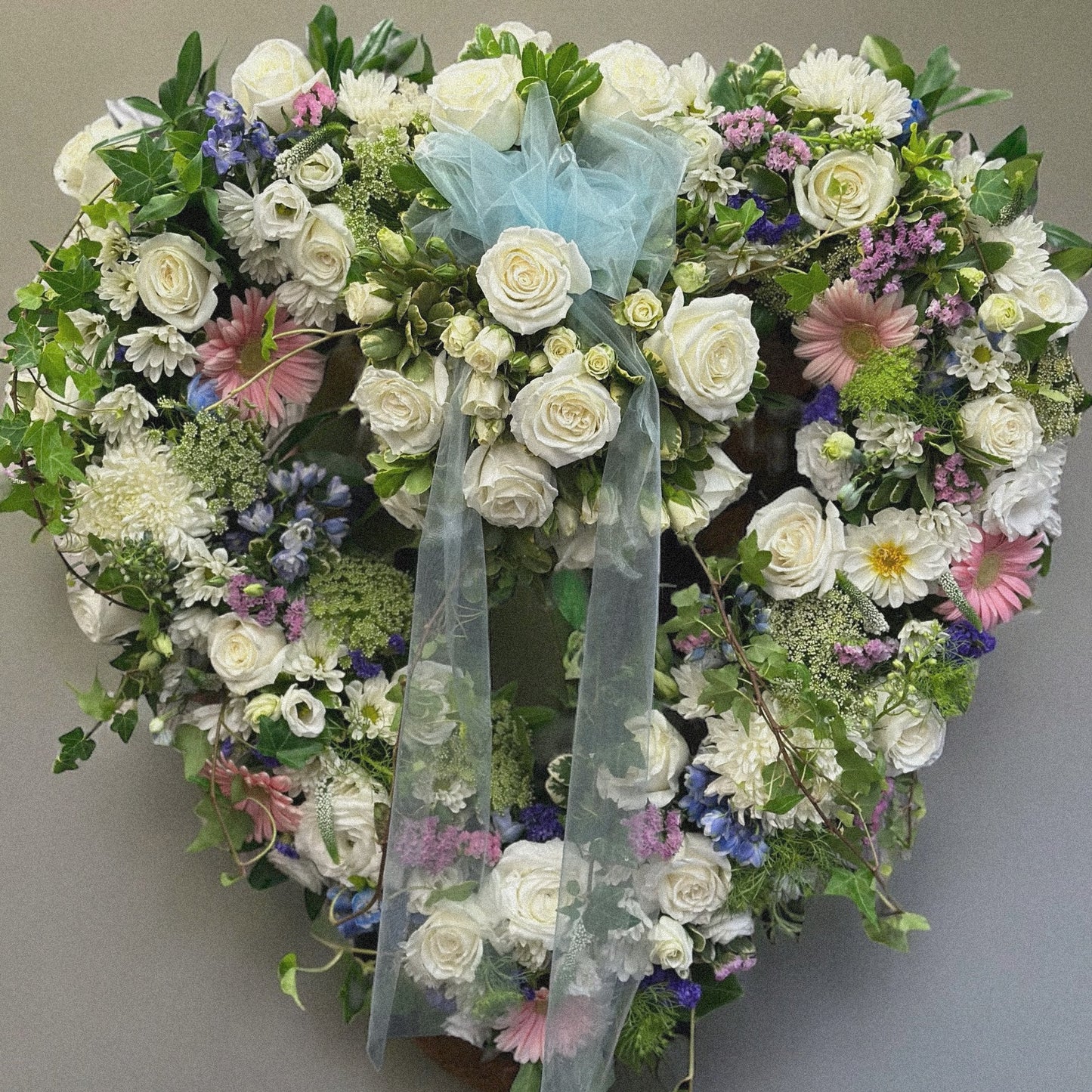 Heartfelt Tribute Wreath with white roses and soft hues for funerals, symbolizes love and sympathy. Best in Toronto, same day delivery.