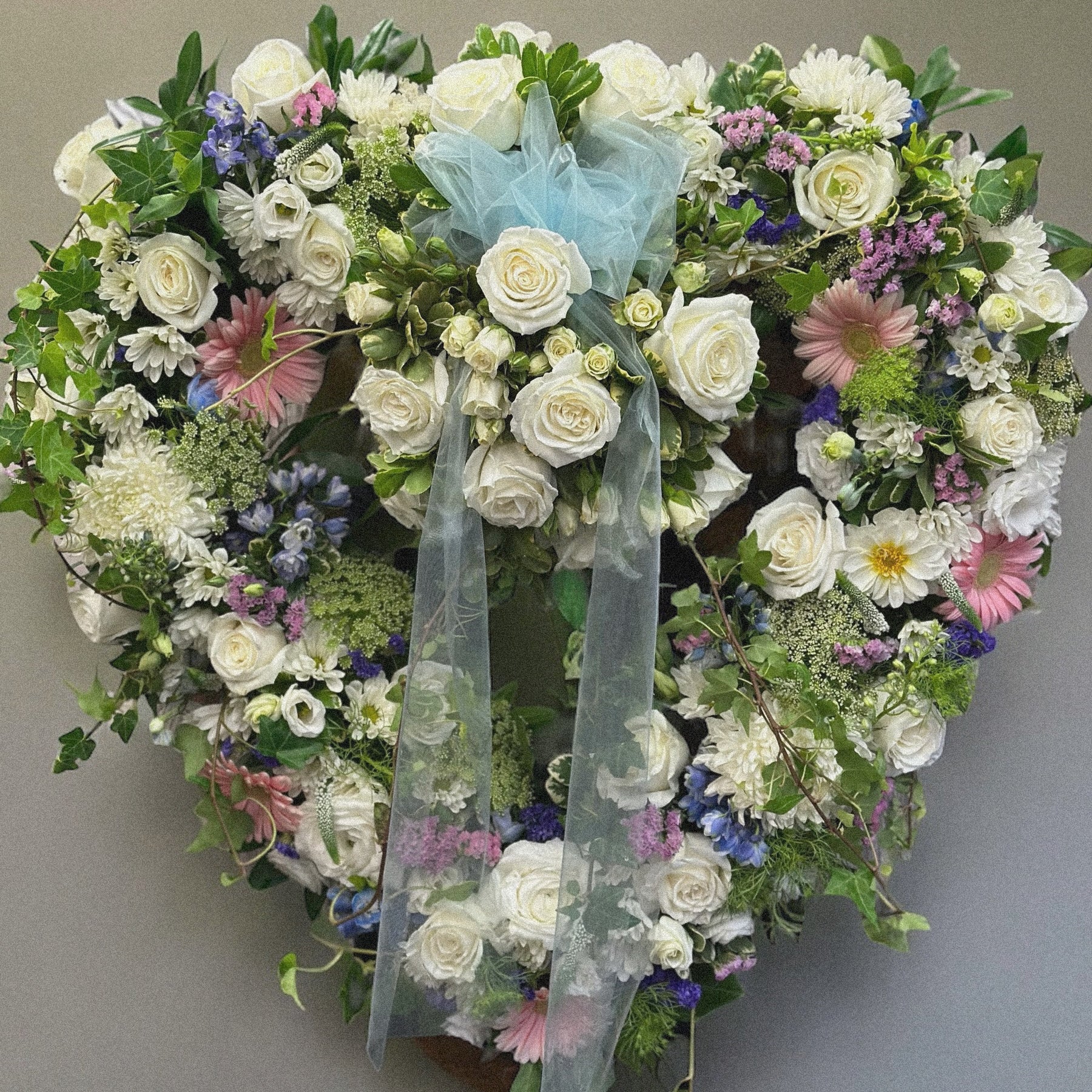 Heartfelt Tribute Wreath with white roses and soft hues for funerals, symbolizes love and sympathy. Best in Toronto, same day delivery.