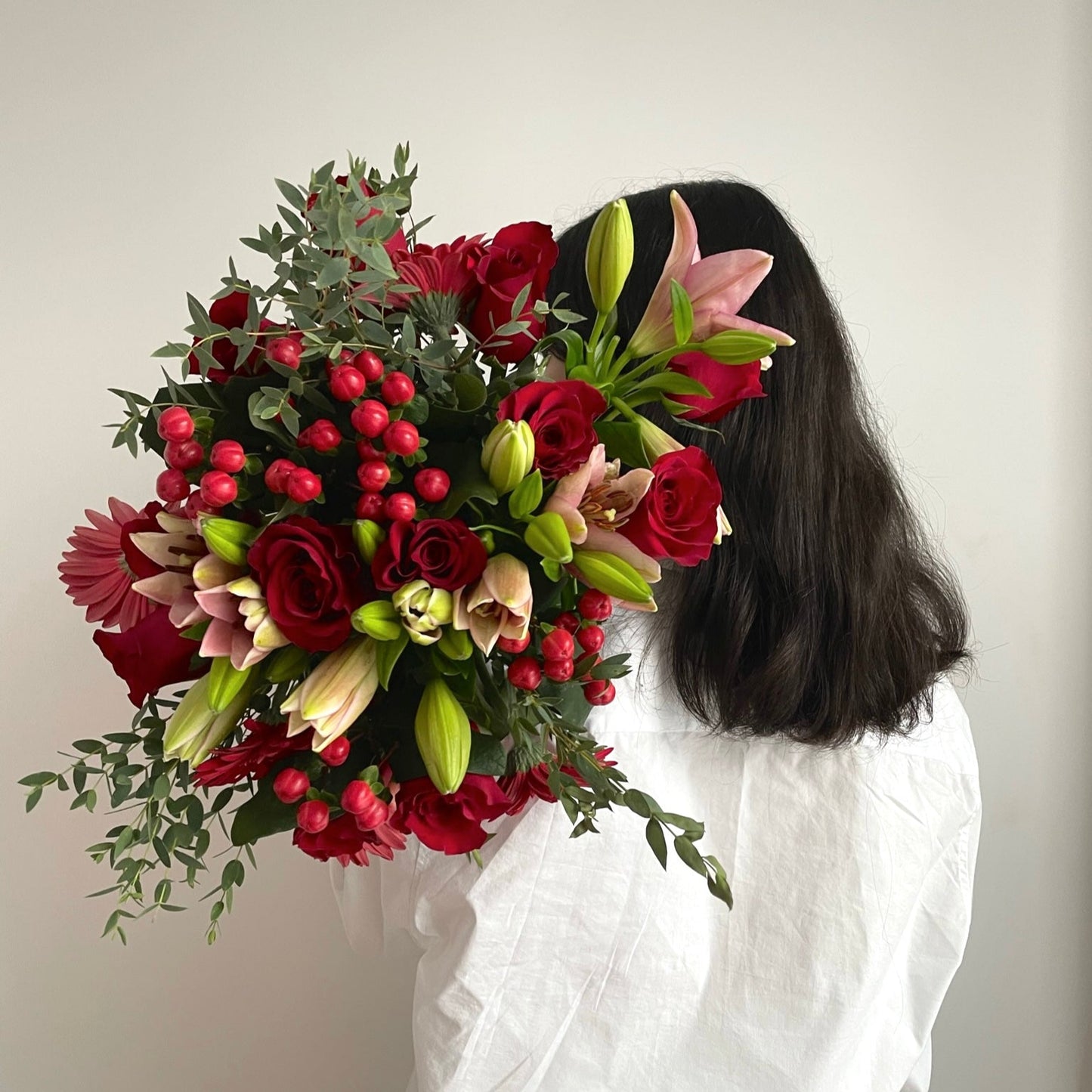 Vibrant mixed flower bouquet with bright gerbera daisies, roses, and fresh greenery, beautifully arranged for any special occasion.