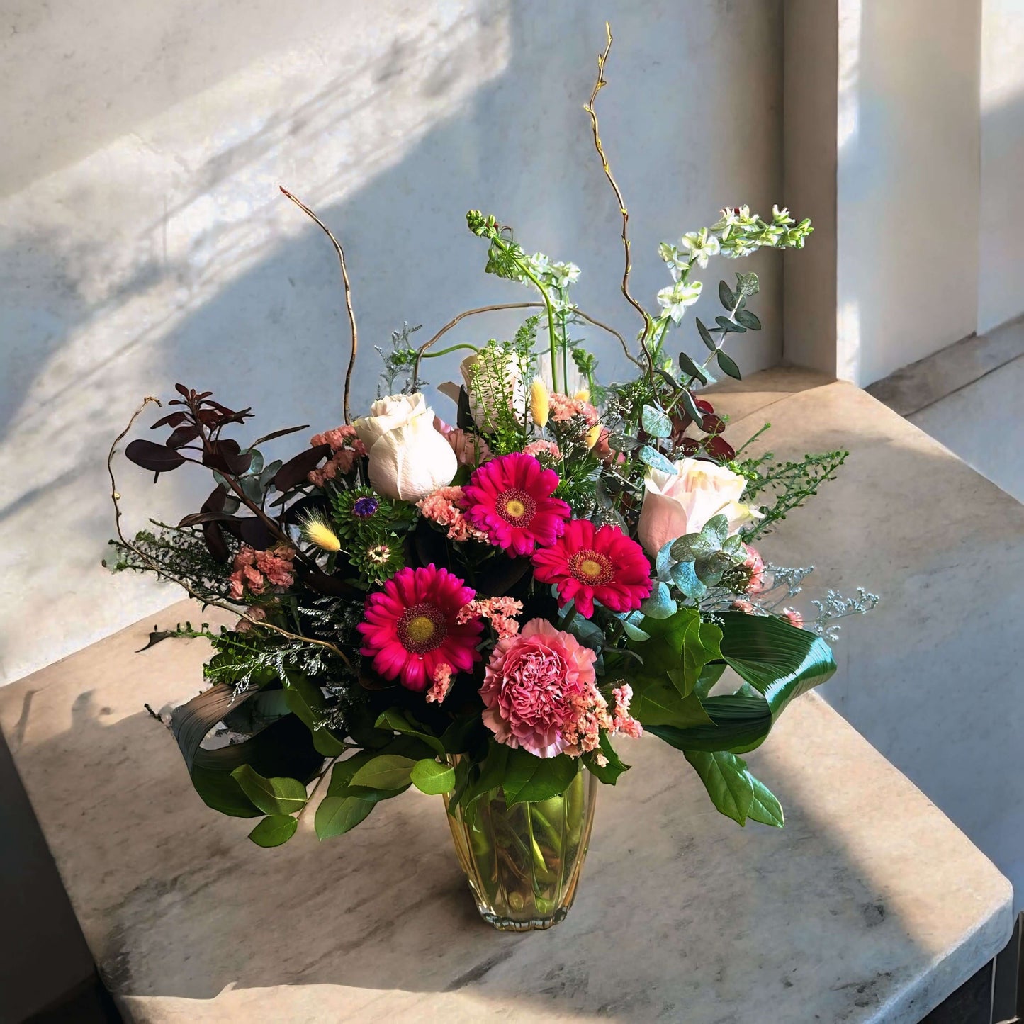 Autumn-inspired bouquet with warm-toned chrysanthemums, roses, and seasonal foliage.