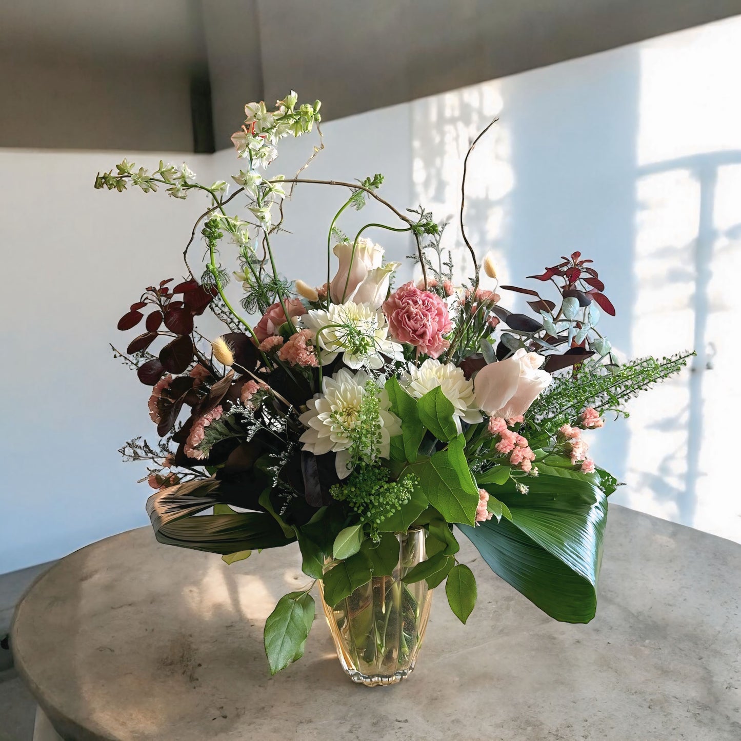 Autumn-inspired bouquet with warm-toned chrysanthemums, roses, and seasonal foliage.