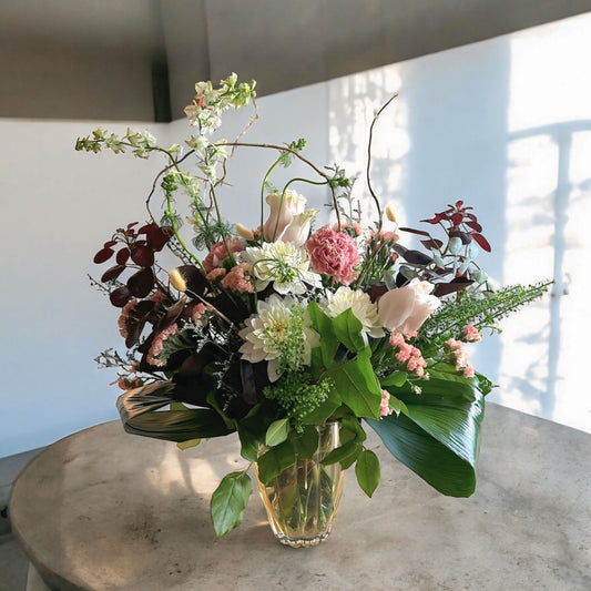 Autumn-inspired bouquet with warm-toned chrysanthemums, roses, and seasonal foliage.