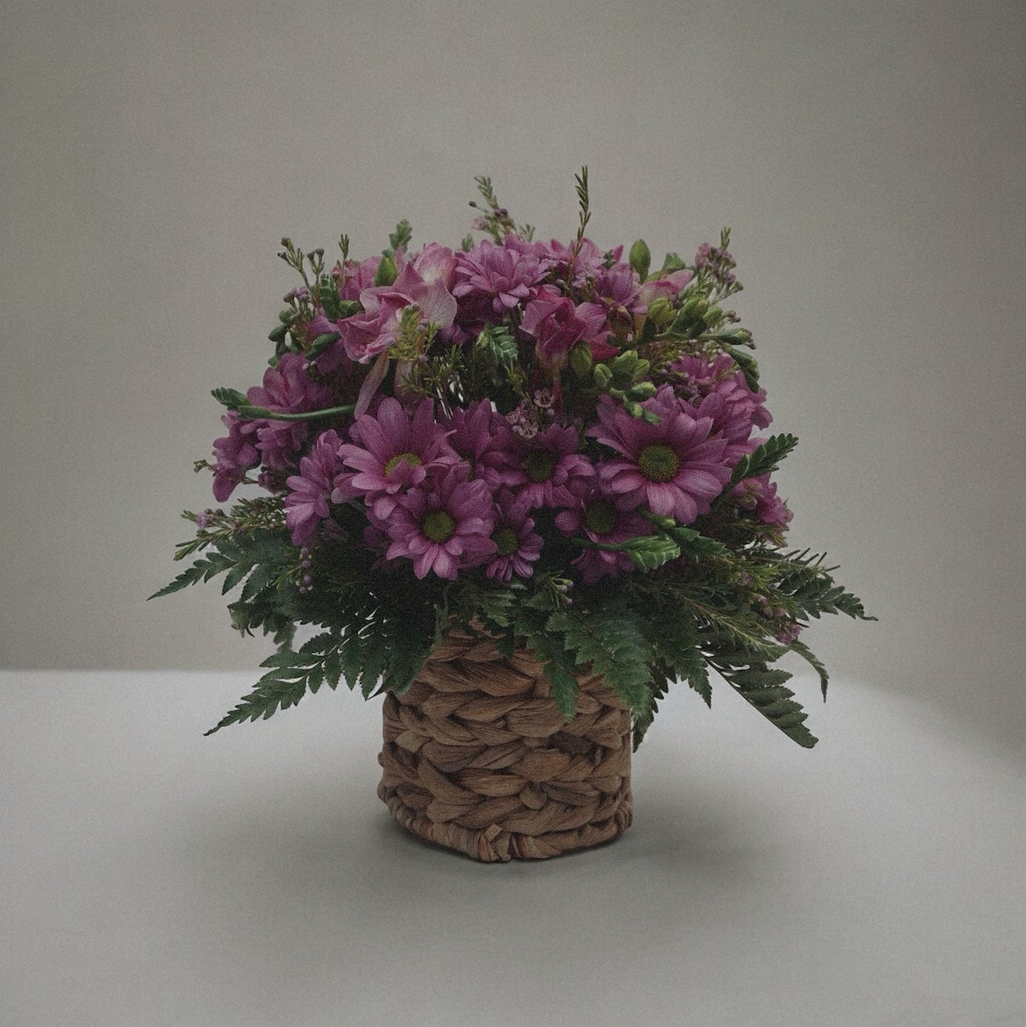 Bright and cheerful spring flower bouquet with colorful tulips, daisies, and fresh greenery.
