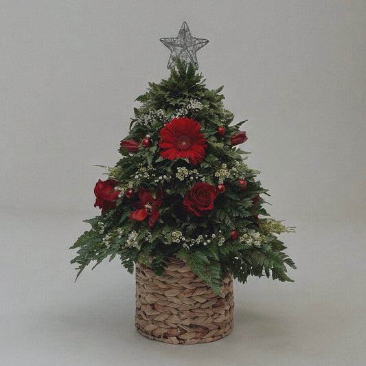 Winter-themed floral centerpiece with white roses, pinecones, and festive greenery, perfect for holiday decor.