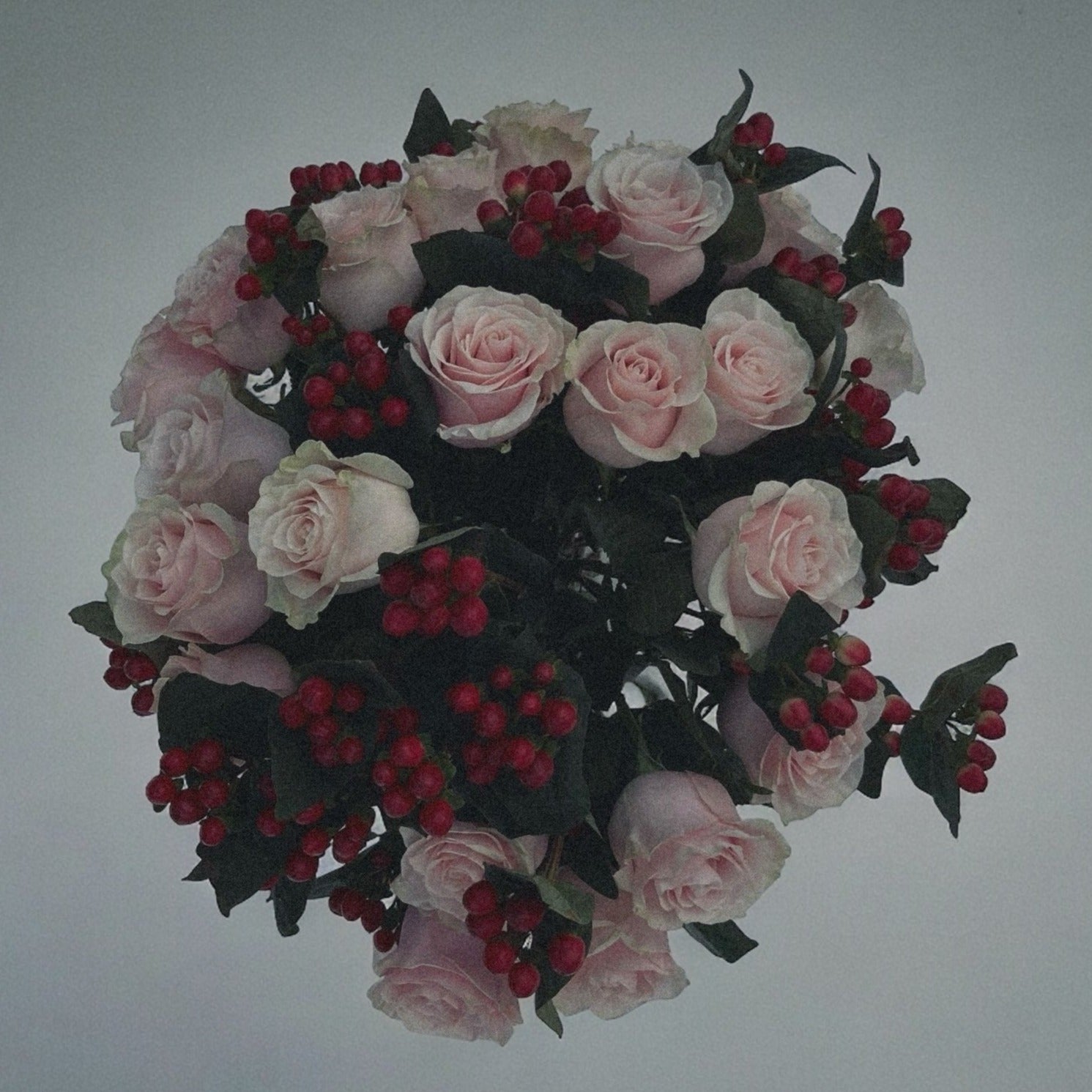 Love-inspired flower arrangement with red tulips, roses, and heart-shaped accents, the ultimate gift for anniversaries