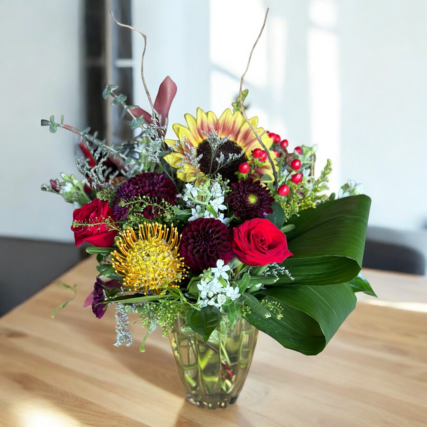 Luxury floral arrangement with red roses, yellow and burgundy dahlias; same day delivery in Toronto and GTA.
