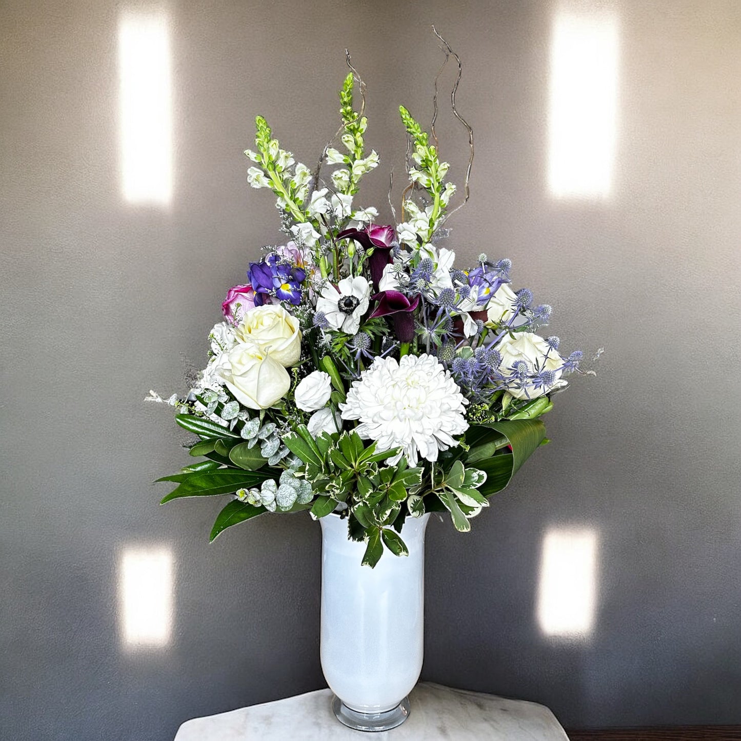 Aster Elegance Bouquet with white roses and purple flowers in a vase, luxury arrangement by best Toronto and GTA florist, fresh and elegant.