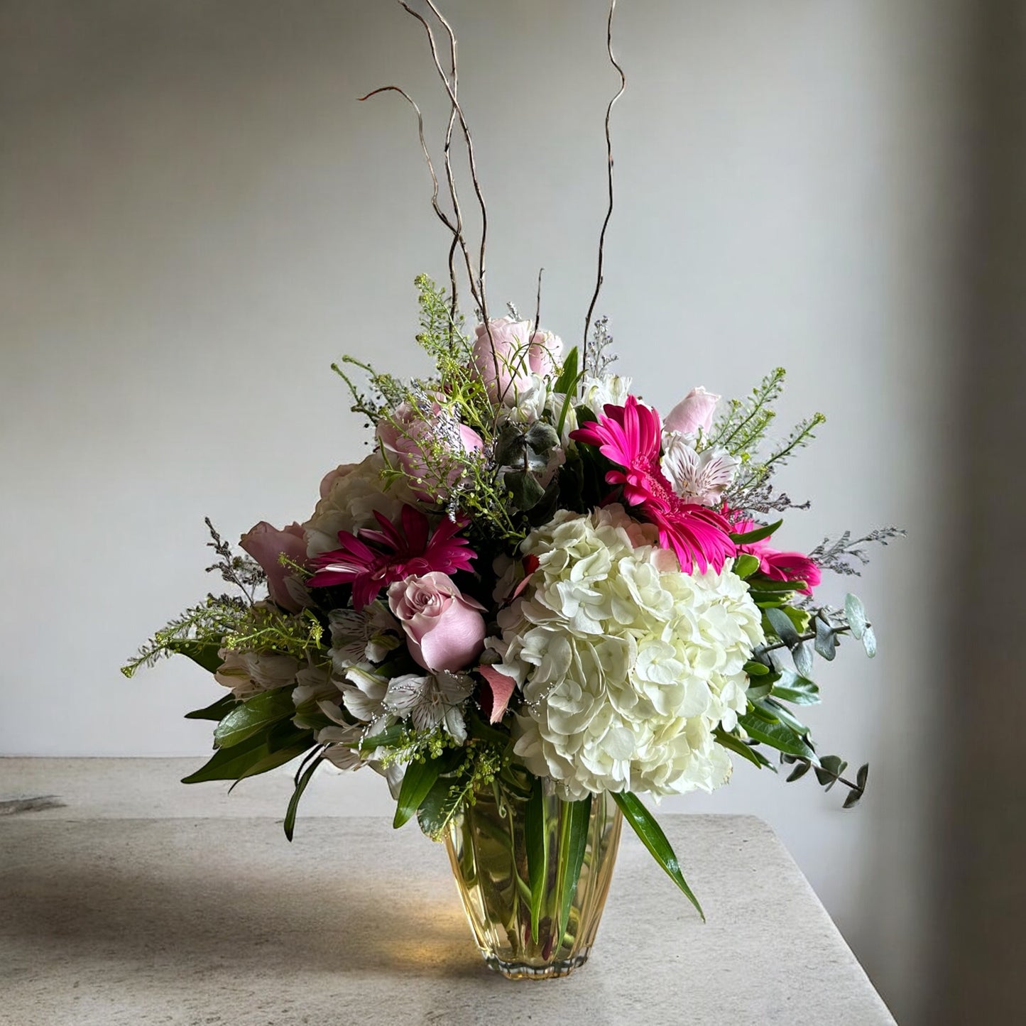 Blushing Elegance floral arrangement in a golden vase, featuring pink and white blooms, perfect for luxury occasions in Toronto.