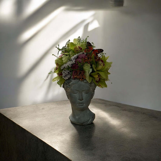 Chic and modern floral centerpiece with delicate orchids, perfect for sophisticated home or event decor.