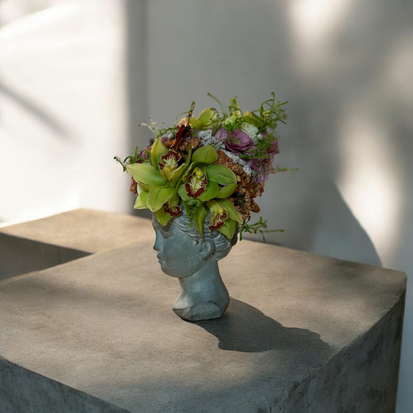 Chic and modern floral centerpiece with delicate orchids, perfect for sophisticated home or event decor.