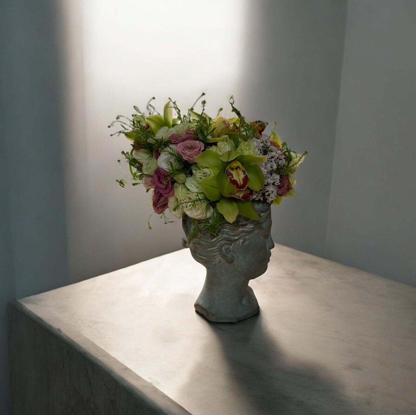 Chic and modern floral centerpiece with delicate orchids, perfect for sophisticated home or event decor.