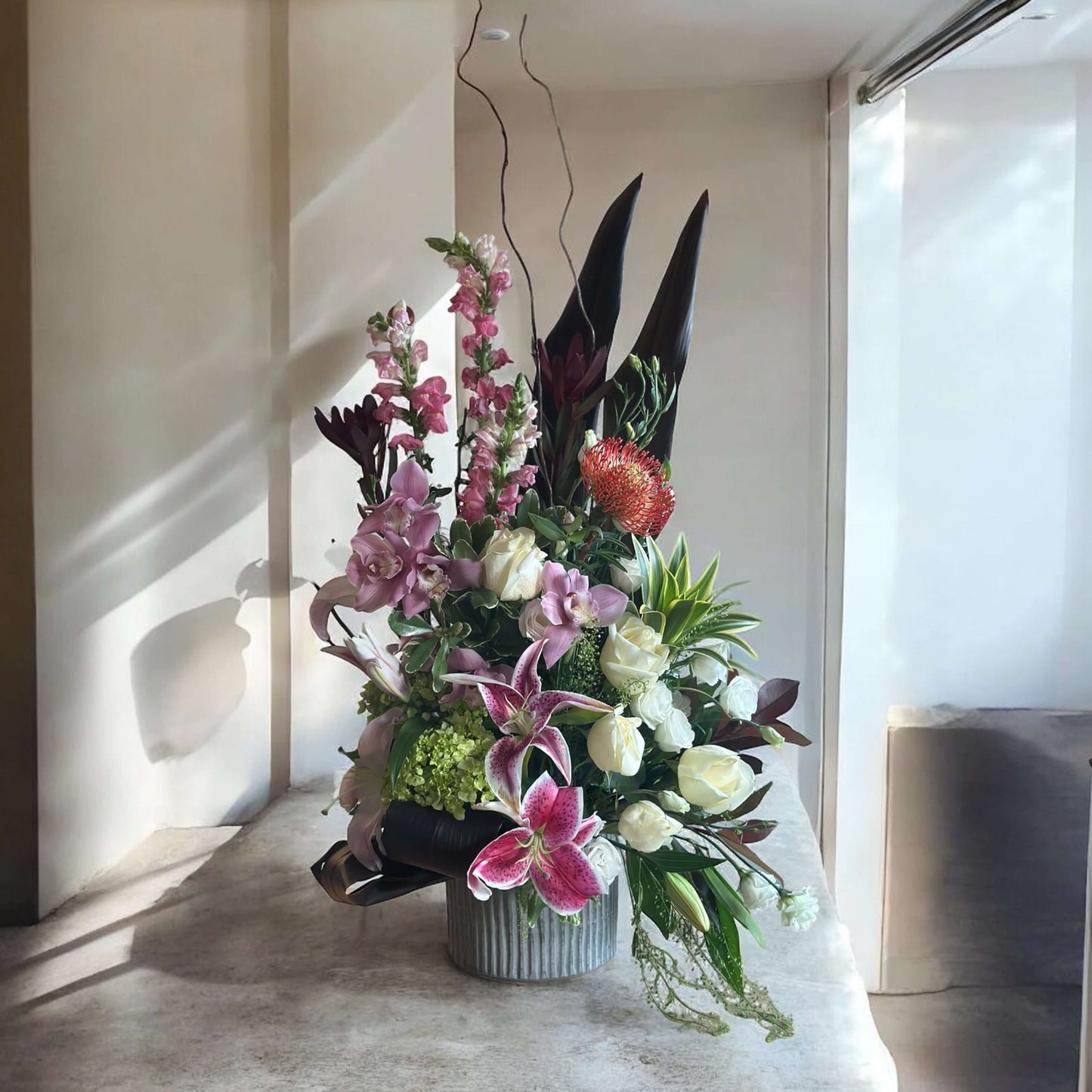 Luxury floral bouquet with handpicked roses, hydrangeas, and greenery in a glass vase, ideal for weddings, anniversaries, and celebrations.