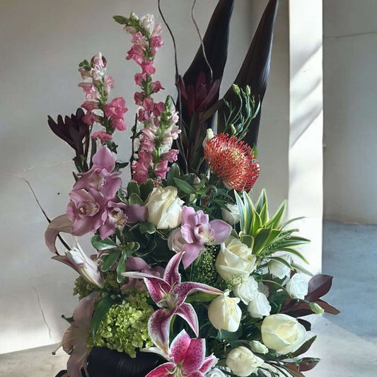 Luxury floral bouquet with handpicked roses, hydrangeas, and greenery in a glass vase, ideal for weddings, anniversaries, and celebrations.