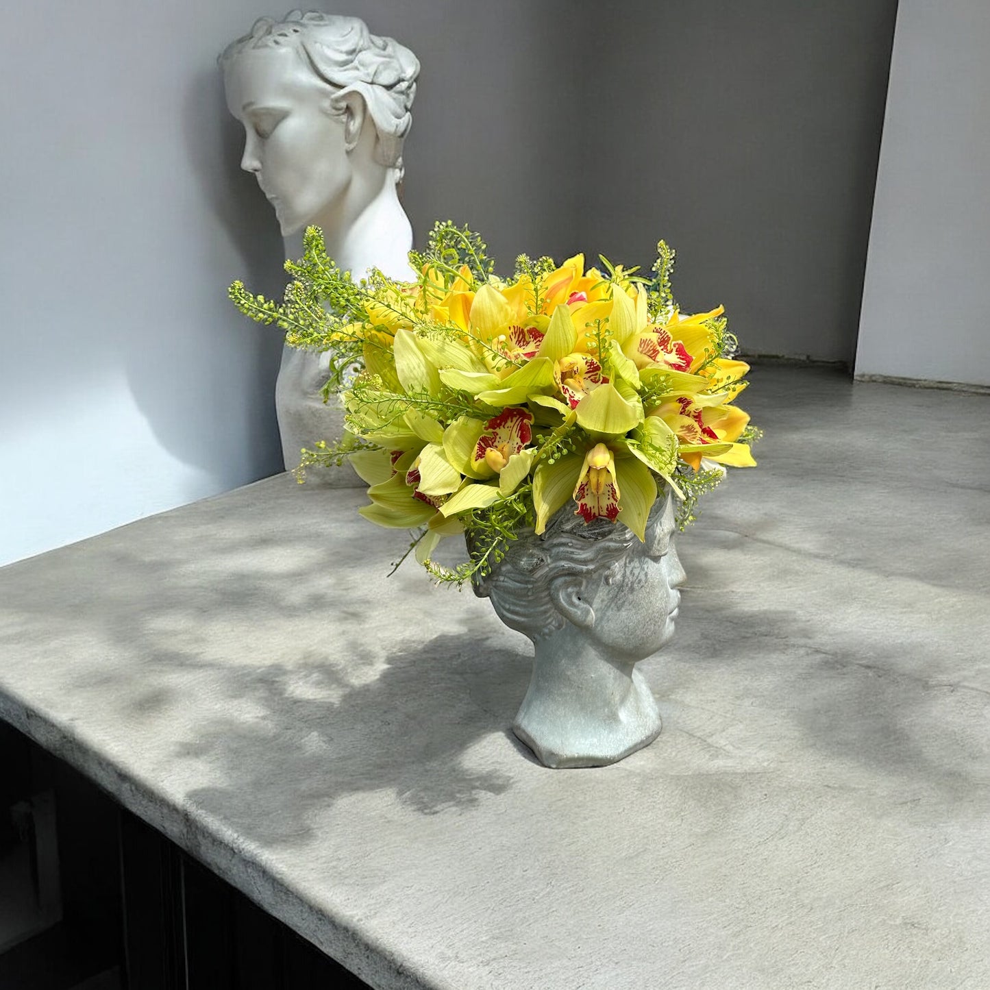 Chic and modern floral centerpiece with delicate orchids, perfect for sophisticated home or event decor.