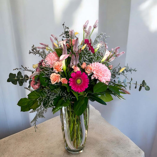 Vibrant mixed flower bouquet with bright gerbera daisies, roses, and fresh greenery, beautifully arranged for any special occasion.