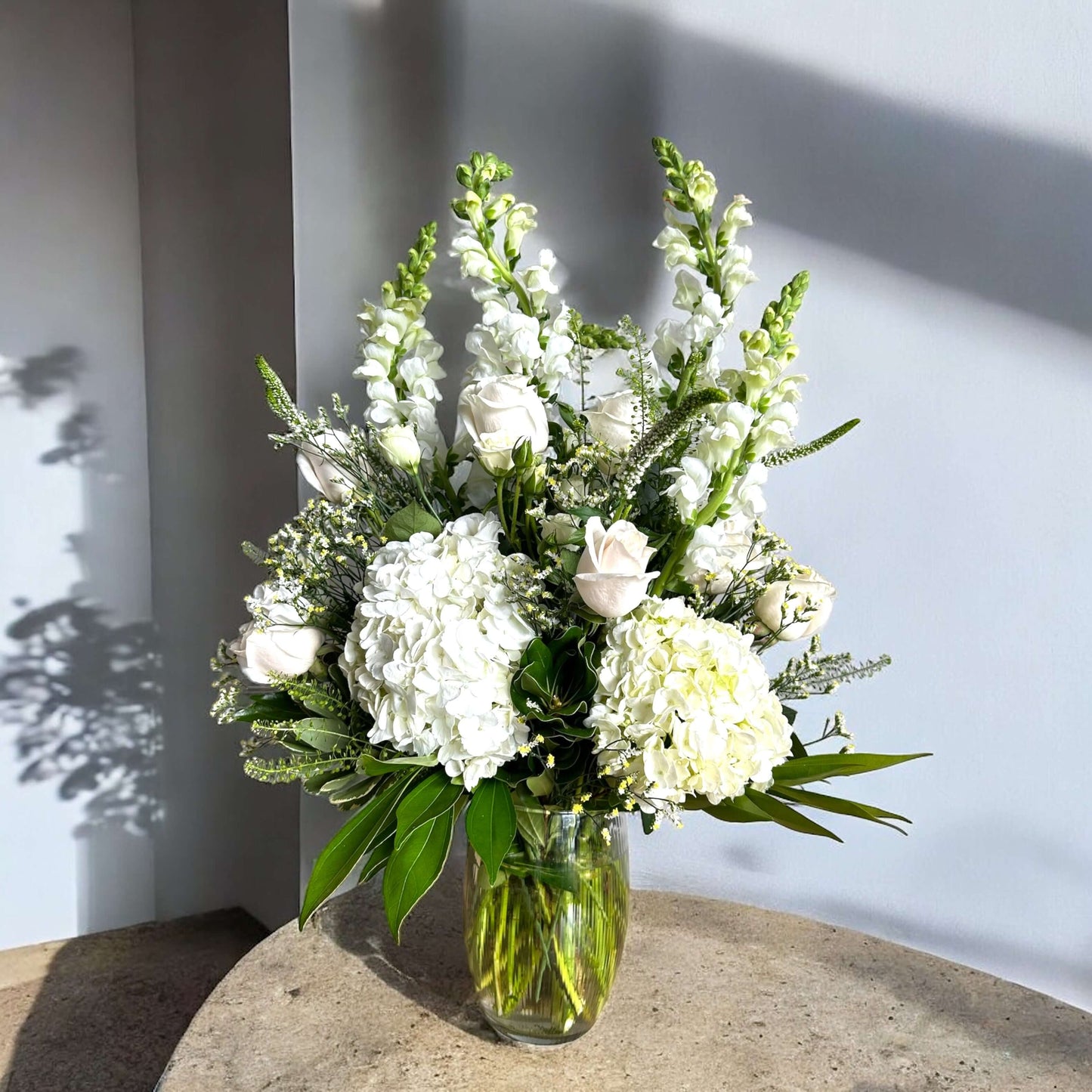 Timeless floral arch decoration featuring white lilies and eucalyptus, creating a stunning wedding backdrop