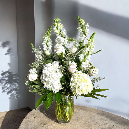 Timeless floral arch decoration featuring white lilies and eucalyptus, creating a stunning wedding backdrop
