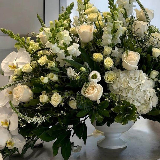 Luxury floral centerpiece with roses, hydrangeas, and pampas grass, ideal for wedding receptions and table settings.