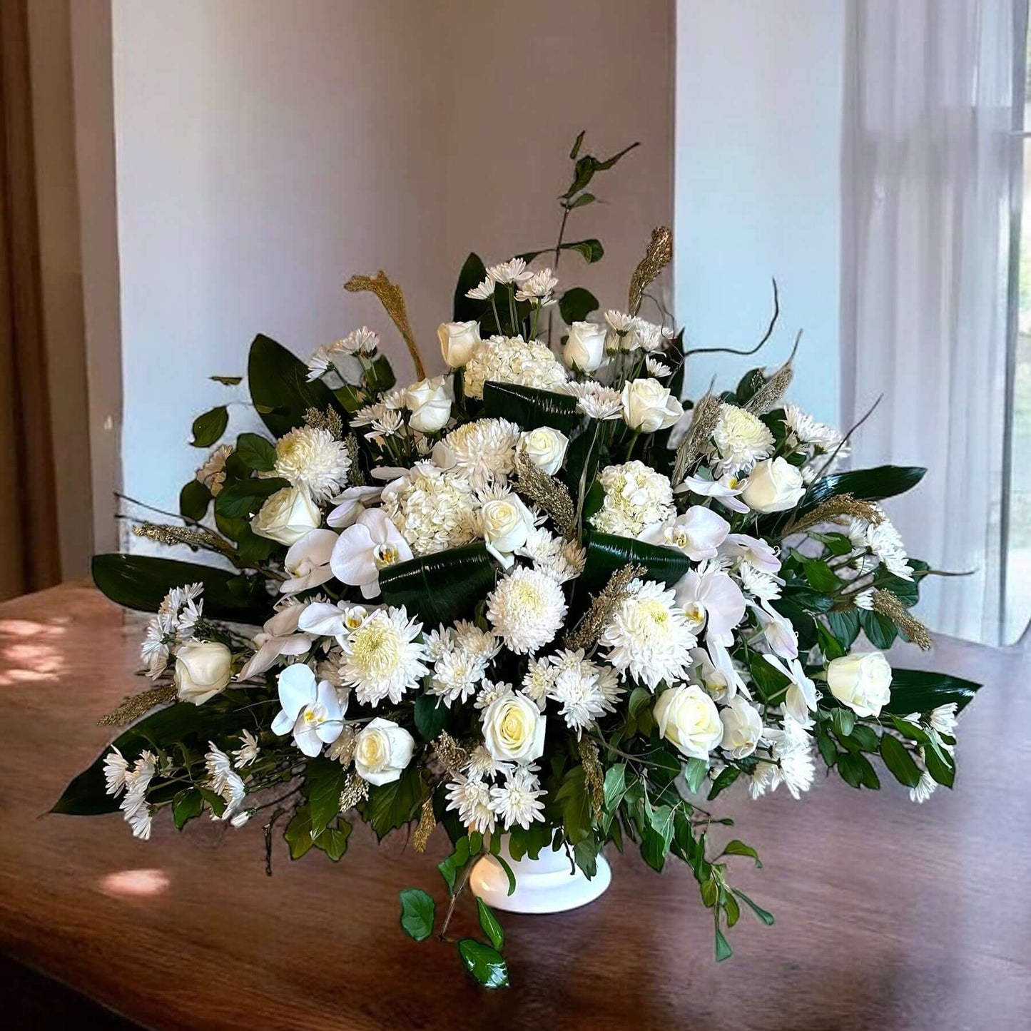 Elegant white sympathy flowers in a luxurious arrangement for tributes and condolences.