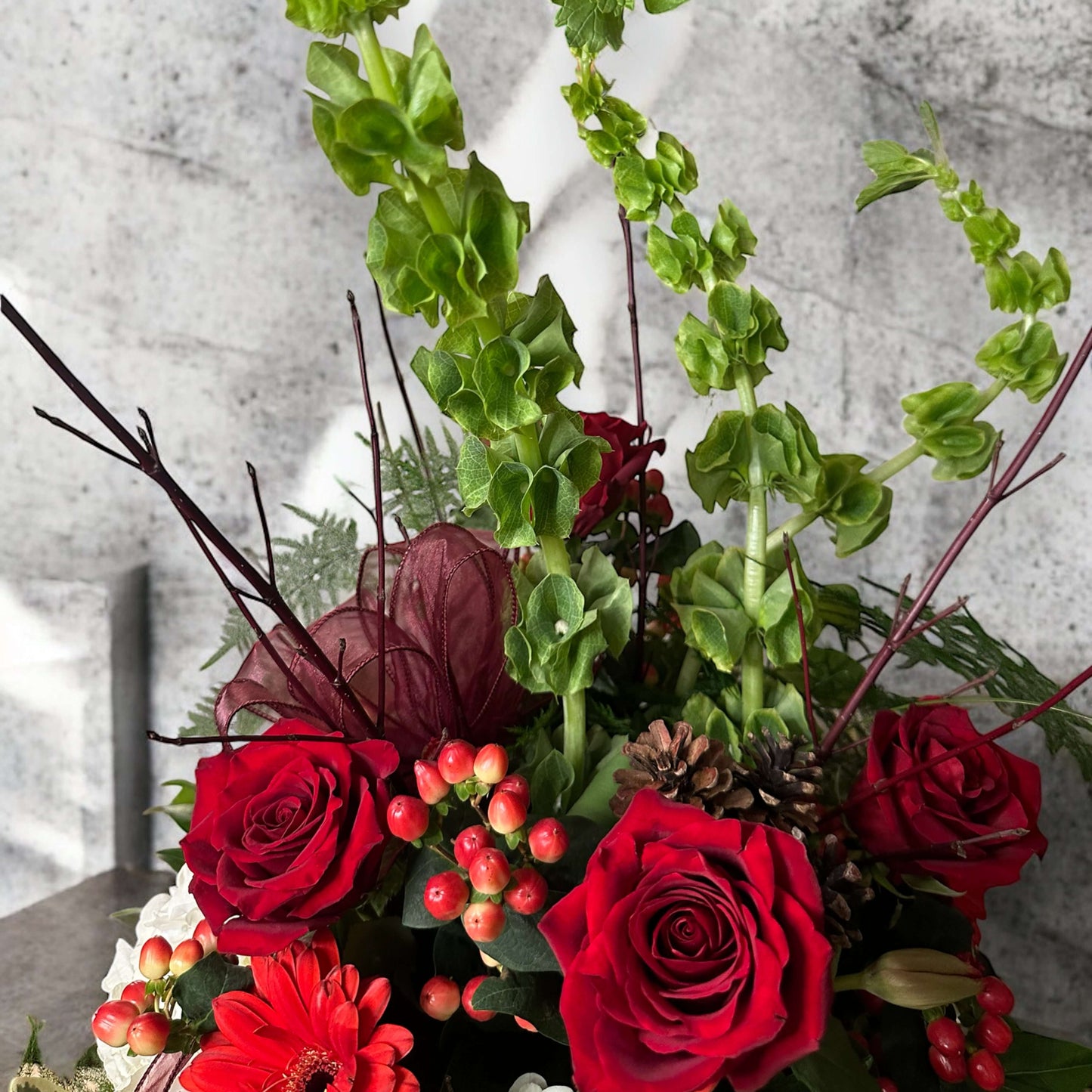 Love-inspired flower arrangement with red tulips, roses, and heart-shaped accents, the ultimate gift for anniversaries