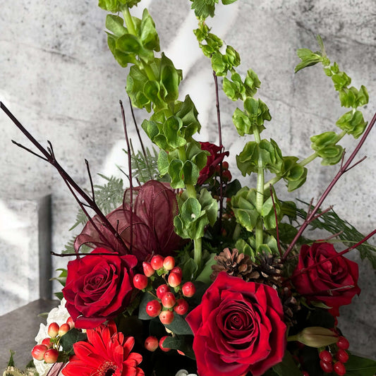Love-inspired flower arrangement with red tulips, roses, and heart-shaped accents, the ultimate gift for anniversaries