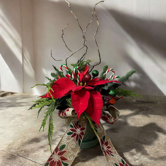 Winter-themed floral wreath with white roses, pinecones, and festive greenery, perfect for holiday decor.