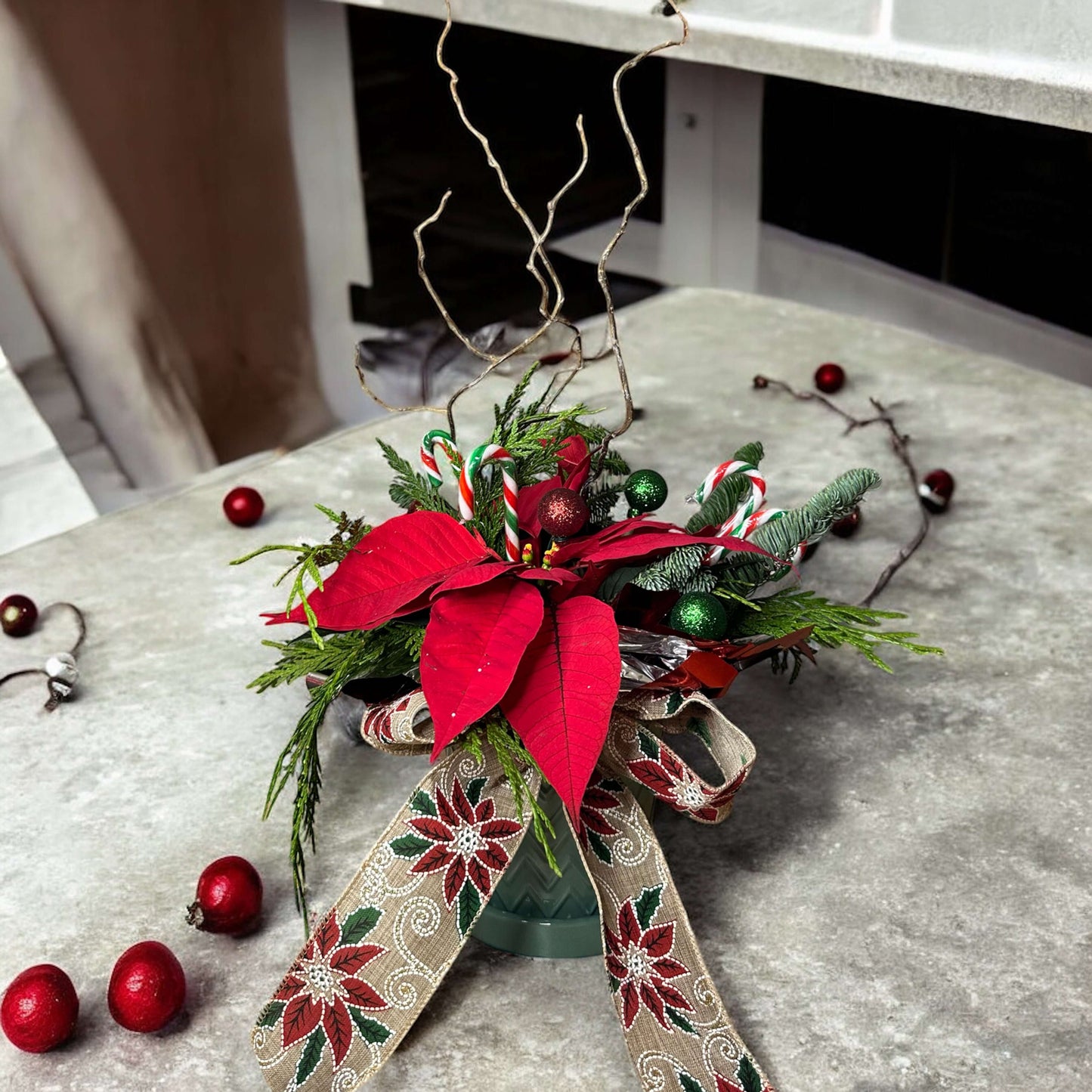 Winter-themed floral wreath with white roses, pinecones, and festive greenery, perfect for holiday decor.