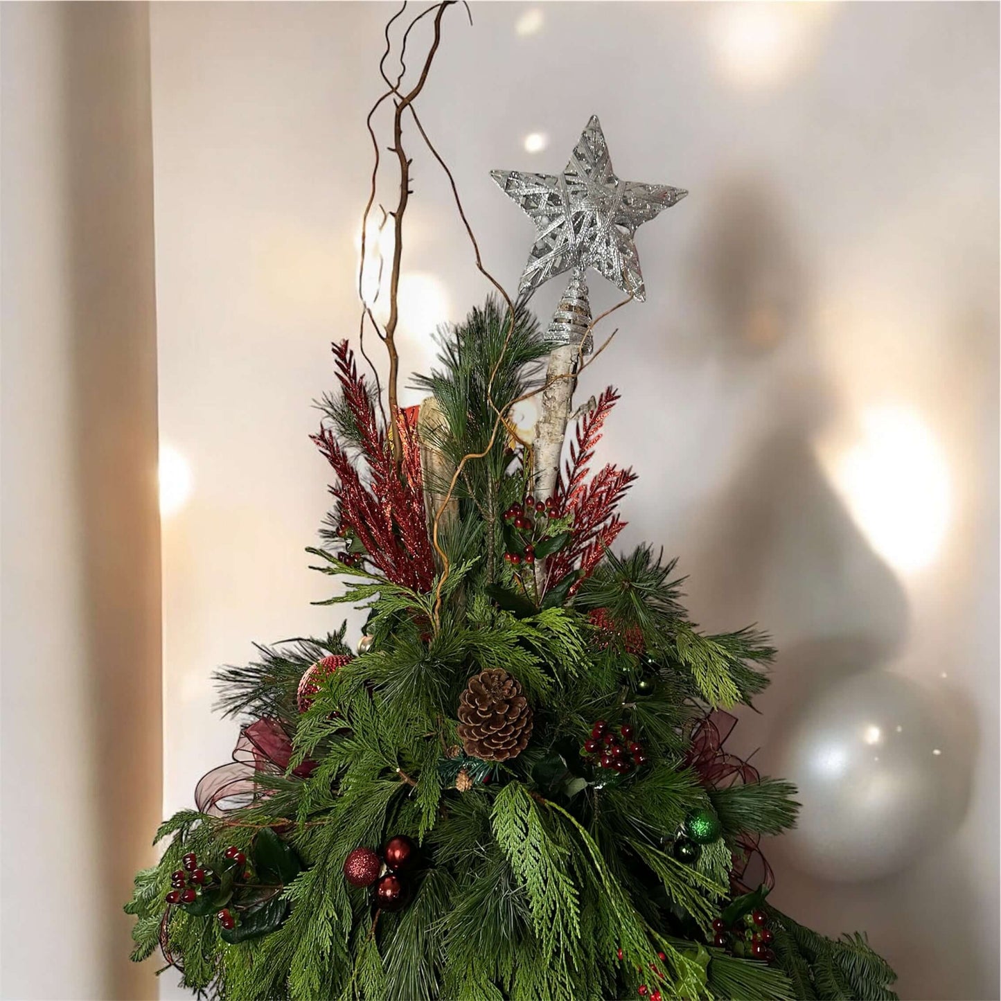 Winter-themed floral urn with white roses, pinecones, and festive greenery, perfect for holiday decor.