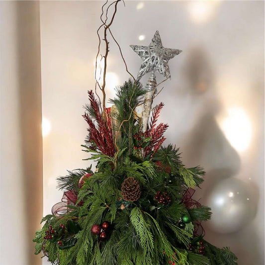 Winter-themed floral urn with white roses, pinecones, and festive greenery, perfect for holiday decor.
