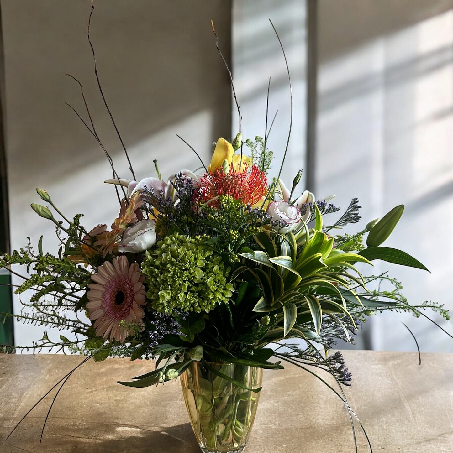 Autumn-inspired bouquet with warm-toned chrysanthemums, sunflowers, and seasonal foliage