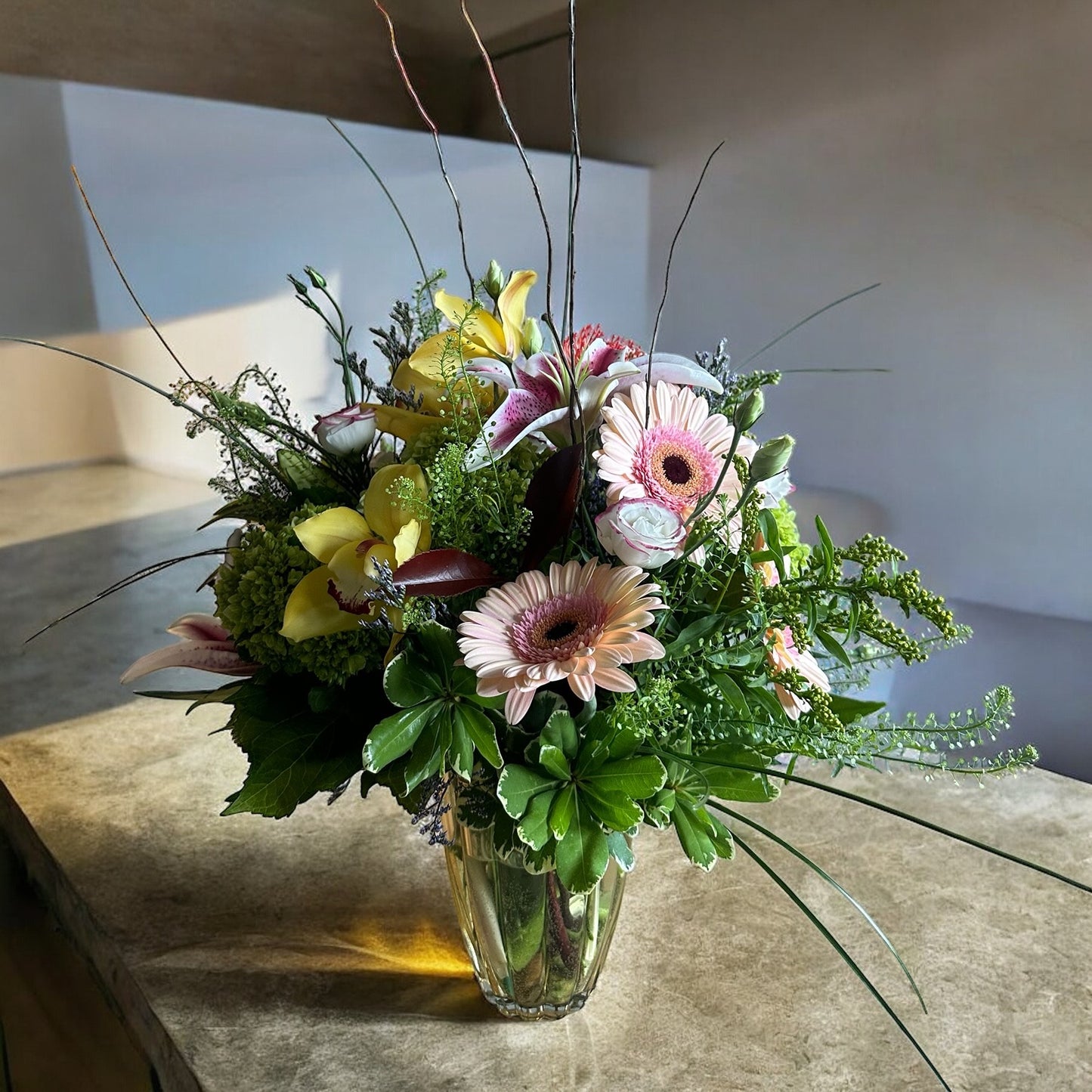 Autumn-inspired bouquet with warm-toned chrysanthemums, sunflowers, and seasonal foliage