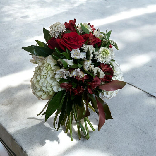 Handcrafted rose bouquet with delicate orchids and eucalyptus, symbolizing eternal love and admiration.